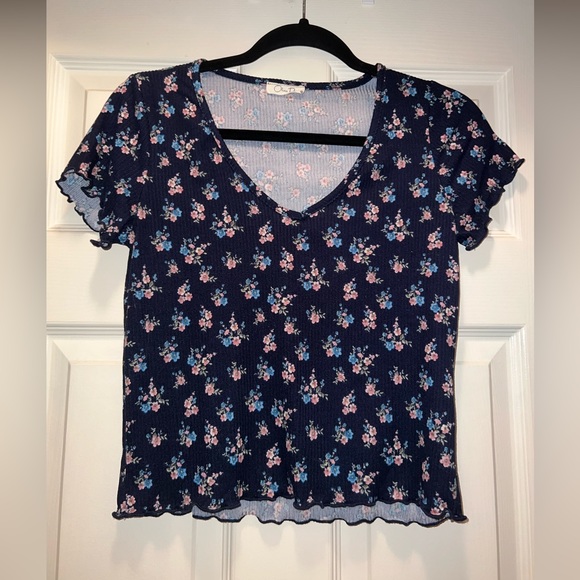 Navy blue tee with pink and blue flowers. - Picture 1 of 3
